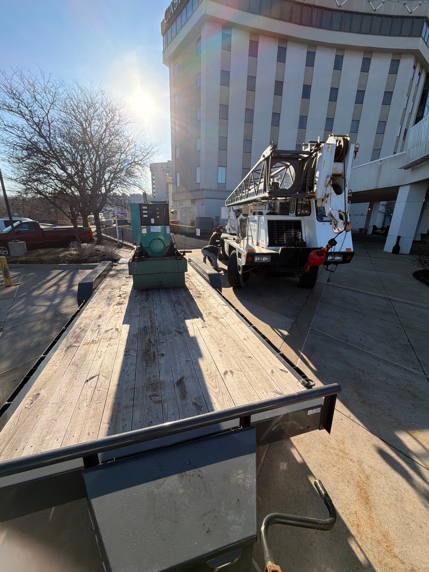 Crane delivering mechanical equipment to a managed commercial property